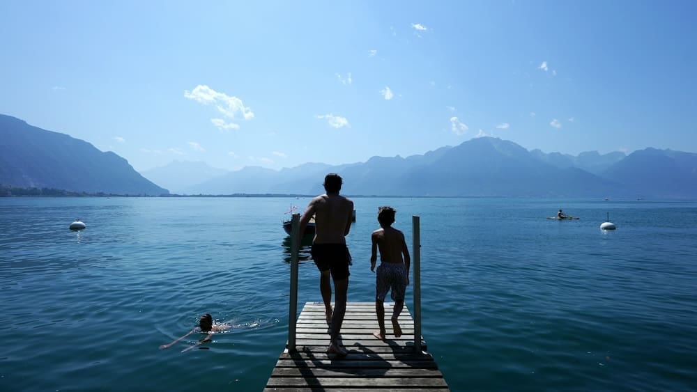 Kids jumping into Alpine lake